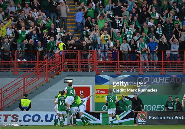 Jason Cummings of Hibernian celebrates scoring the second goal of the match with his team mates, in front of the traveling Hibernian fans during the...