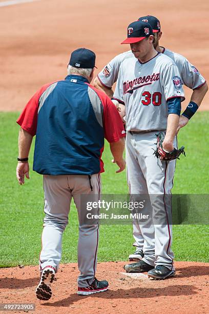 Mananger Ron Gardenhire of the Minnesota Twins takes starting pitcher Kevin Correia out of the game during the fifth inning against the Cleveland...