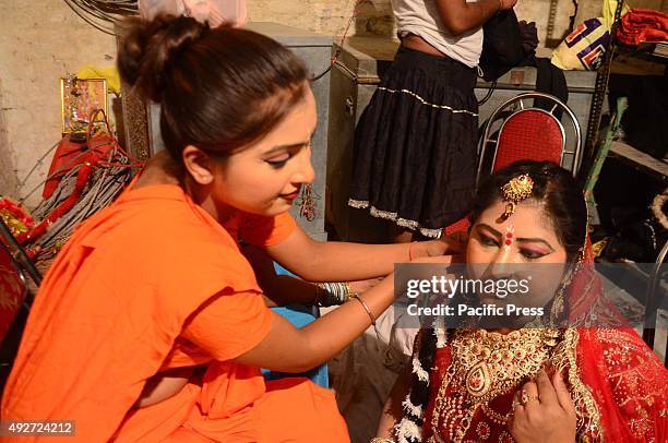 An Indian performer artist prepare to another performer of the 'Ram leela', a religious Drama on God Ram's life on the occasion of Dussehra Festival...