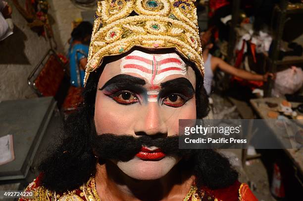 An Indian performer dressed as "Ravana" of the 'Ram leela' react to camera after getting ready to perform on the stage on the occasion of Dussehra...