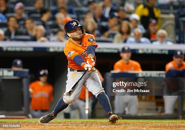 Jose Altuve of the Houston Astros connects on a RBI hit against the New York Yankees during the American League Wild Card Game at Yankee Stadium on...