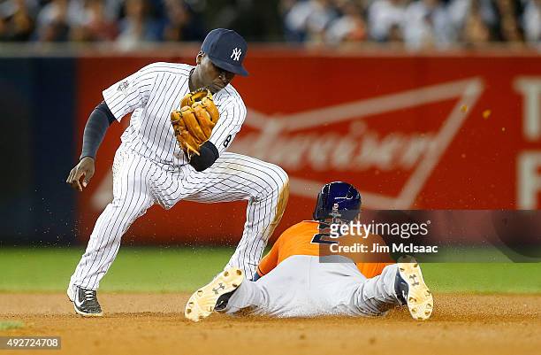Jonathan Villar of the Houston Astros steals against Didi Gregorius of the New York Yankees during the American League Wild Card Game at Yankee...