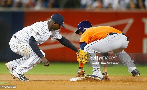 Jonathan Villar of the Houston Astros steals against Didi Gregorius of the New York Yankees during the American League Wild Card Game at Yankee...