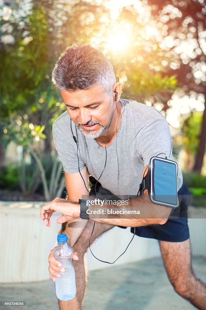 Runner looking at sport watch