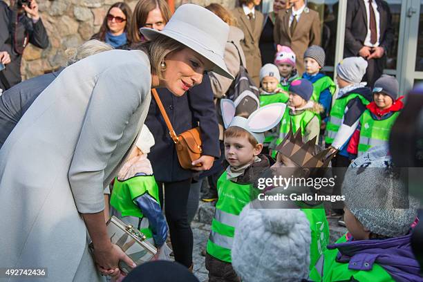 Her Royal Highness Mathilde Queen Of Belgium speaks to children during her visit to the Forest Education Center on October 14, 2015 in Warsaw,...