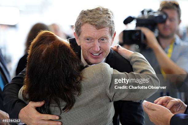 Newly-elected NASCAR Hall of Fame driver Bill Elliott receives a hug as he makes his way through the crowd at the Hall of Fame after a news...