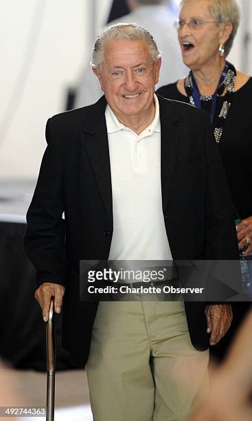 Newly-elected NASCAR Hall of Fame driver Rex White smiles as he makes his way to the next television interview at the NASCAR Hall of Fame after a...
