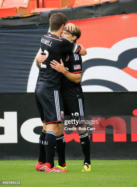 Chris Rolfe of D.C. United celebtrates after scoring a goal against the Houston Dynamo with teammate Bobby Boswell during the first half at RFK...