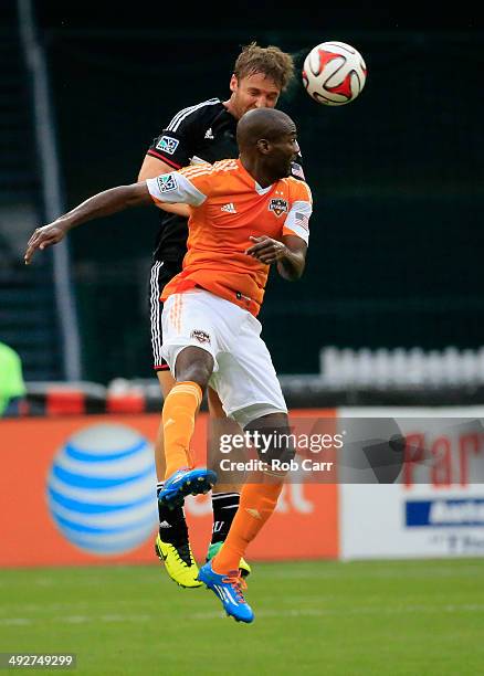 Jeff Parke of D.C. United and Omar Cummings of Houston Dynamo go up for the ball during the first half at RFK Stadium on May 21, 2014 in Washington,...