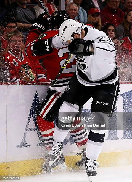 Dustin Brown of the Los Angeles Kings checks Johnny Oduya of the Chicago Blackhawks in the first period of Game Two of the Western Conference Final...