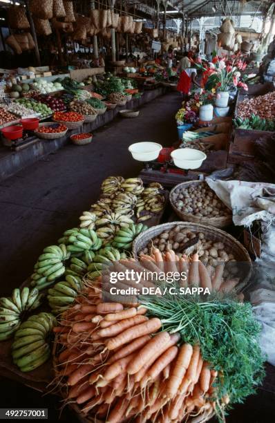 Fruit and vegetables laid out in the sun in a market in Saint Denis, Reunion, Mascarene Islands.