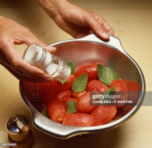 Peeled tomatoes with basil and salt. Peeled tomatoes step 2.