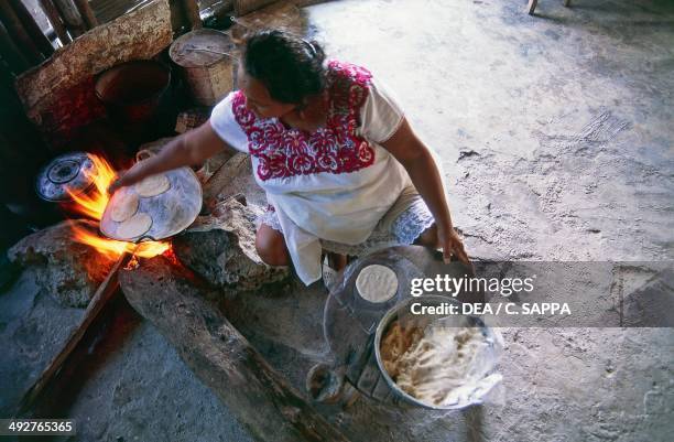 Woman preparing tortillas, Campeche, Mexico.