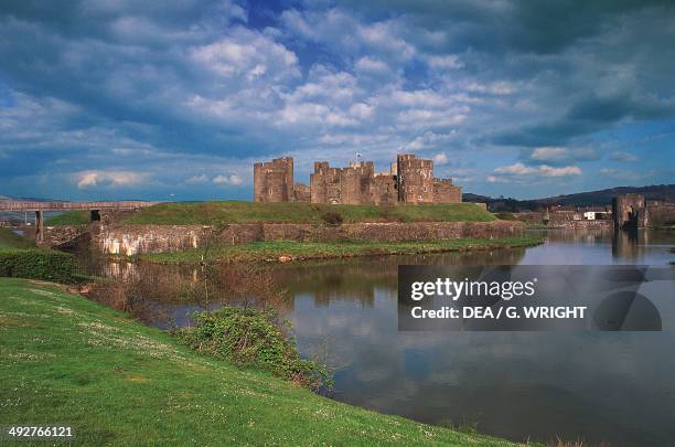 The moat and Caerphilly castle, 13th century, largest medieval fortress of Wales, United Kingdom.