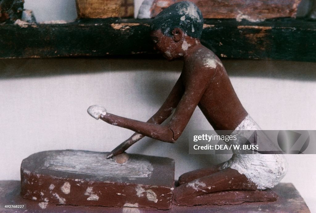 Statuette of a woman who is making bread...