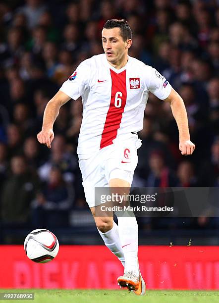 Tomasz Jodlowiec of Poland lines up for the national anthem during the EURO 2016 Qualifier between Scotland and Poland at Hamden Park on October 8,...