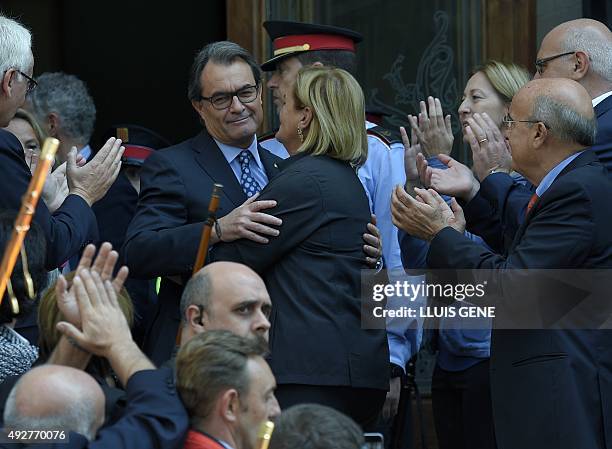 Catalonia's regional government president and leader of the Catalan Democratic Convergence Artur Mas , is hugged by Catalan Parliament president...