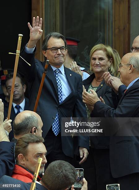 Catalonia's regional government president and leader of the Catalan Democratic Convergence Artur Mas , waves as he exits the TSJC beside Catalan...