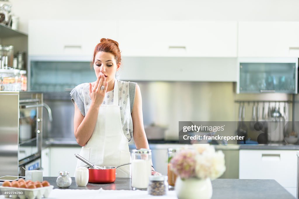 Woman cooking a cake on the kitchen