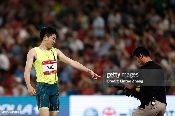 Xie Wenjun of China celebrates winning the men's 110-meter hurdles during 2014 IAAF World Challenge Beijing at National Stadium on May 21, 2014 in...