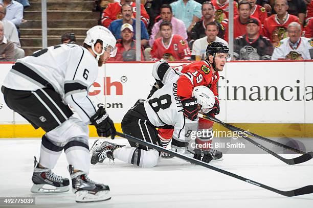 Jonathan Toews of the Chicago Blackhawks holds onto Drew Doughty of the Los Angeles Kings in Game Two of the Western Conference Final during the 2014...