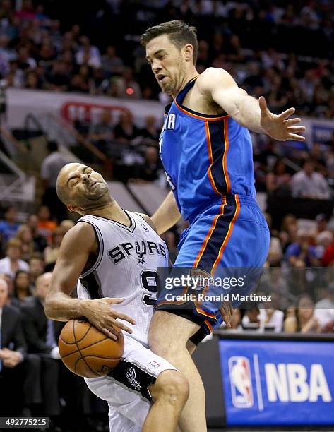 Tony Parker of the San Antonio Spurs is fouled by Nick Collison of the Oklahoma City Thunder in the first quarter in Game Two of the Western...