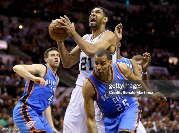 Tim Duncan of the San Antonio Spurs goes up for a shot against Thabo Sefolosha of the Oklahoma City Thunder in the first quarter in Game Two of the...