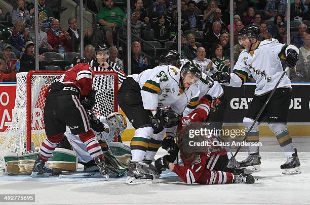 Brady Austin of the London Knights puts Tyler Bertuzzi of the Guelph Storm down in Game Six at the 2014 MasterCard Memorial Cup at Budweiser Gardens...