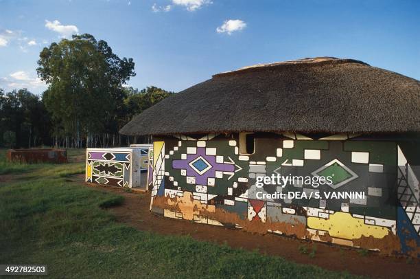 Houses painted with murals in a Ndebele village, South Africa.