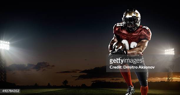 american football in action - american football field low angle stock pictures, royalty-free photos & images