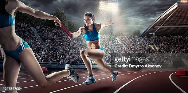 running pass on . stadium - relay teamwork stock pictures, royalty-free photos & images