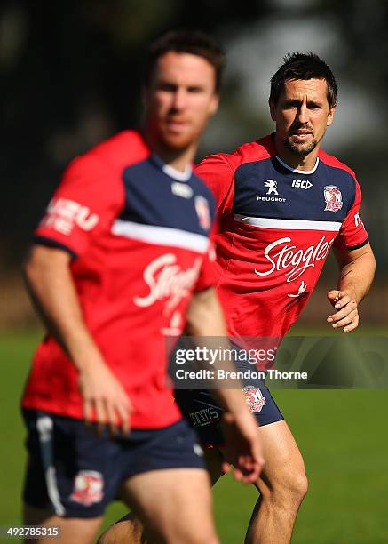 Mitchell Pearce and James Maloney of the Roosters run drills during a Sydney Roosters NRL training session at Kippax Lake on May 22, 2014 in Sydney,...