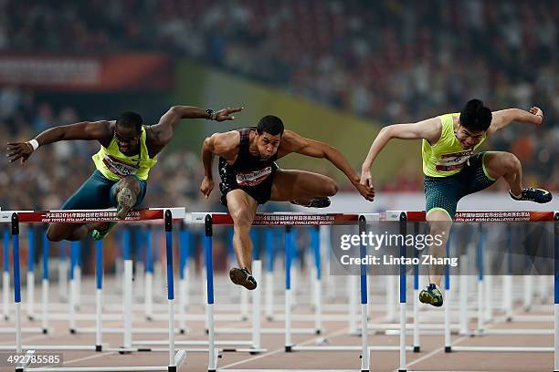 Chinese hurdler Xie Wenjun crosses the finishing line as Ryan Wilson and Dayron Robles of Cuba follow during the Men's 110-meter hurdles of 2014 IAAF...