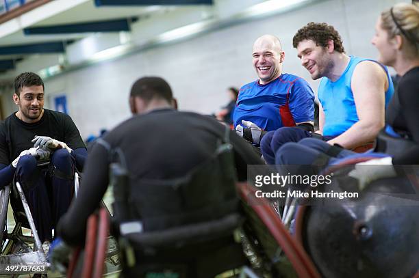 disabled wheelchair rugby athletes in sports hall - wheelchair rugby foto e immagini stock