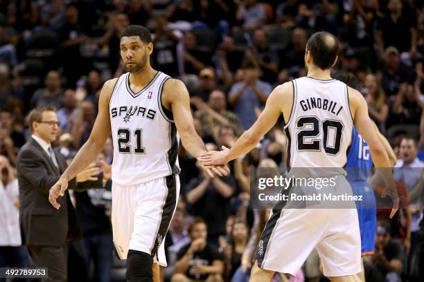 Tim Duncan of the San Antonio Spurs celebrates with Manu Ginobili in the first half against the Oklahoma City Thunder in Game Two of the Western...