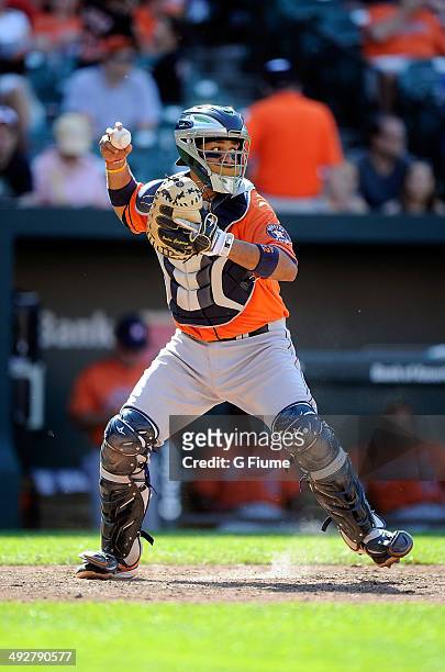 Carlos Corporan of the Houston Astros throws the ball to second base against the Baltimore Orioles at Oriole Park at Camden Yards on May 11, 2014 in...