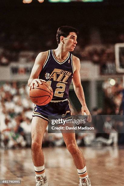 John Stockton of the Utah Jazz dribbles the ball during an NBA game against the Phoenix Suns played on April 9, 1990 at the Arizona Veterans Memorial...