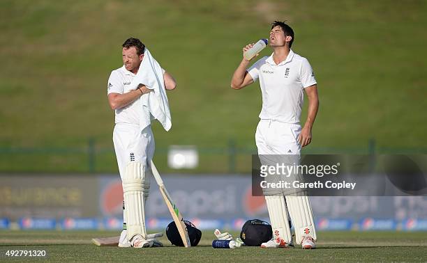 Ian Bell and England captain Alastair Cook cool down during day three of the 1st Test between Pakistan and England at Zayed Cricket Stadium on...