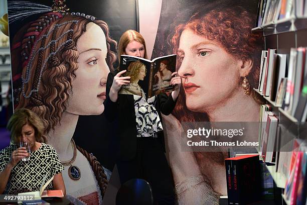Woman poses with the book 'Dialog der Meisterwerke' at the 2015 Frankfurt Book Fair on October 15, 2015 in Frankfurt am Main, Germany. The 2015 fair,...