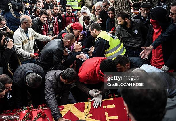 Relatives mourn near the grave of Serdar Ben, a victim of the twin bombings in Ankara, during his funeral in Istanbul on October 15, 2015. Turkey...
