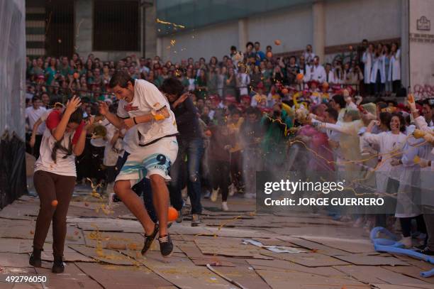 Food is thrown at freshman year medical students during the faculty of medicine hazing at the University of Granada, in Granada on October 15, 2015....