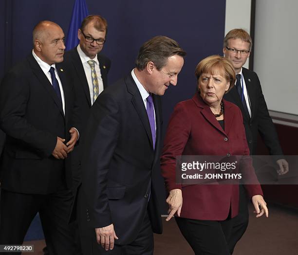 Britain Prime minister David Cameron speaks with German Chancellor Angela Merkel , as Bulgarian Prime minister Boyko Borissov speaks with Finnish...