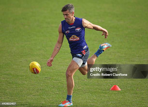 Daniel Giansiracusa of the Bulldogs chases the ball during a Western Bulldogs AFL training session at Whitten Oval on May 22, 2014 in Melbourne,...