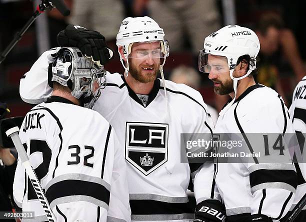 Jonathan Quick, Jeff Carter and Justin Williams of the Los Angeles Kings celebrate their 6 to 2 win over the Chicago Blackhawks in Game Two of the...