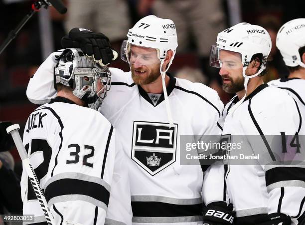 Jonathan Quick, Jeff Carter and Justin Williams of the Los Angeles Kings celebrate their 6 to 2 win over the Chicago Blackhawks in Game Two of the...