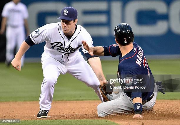 Joe Mauer of the Minnesota Twins steals second base as Jedd Gyorko of the San Diego Padres loses the ball during the sixth inning of a baseball game...