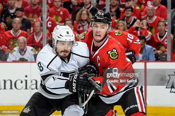 Drew Doughty of the Los Angeles Kings and Jonathan Toews of the Chicago Blackhawks get physical in Game Two of the Western Conference Final during...