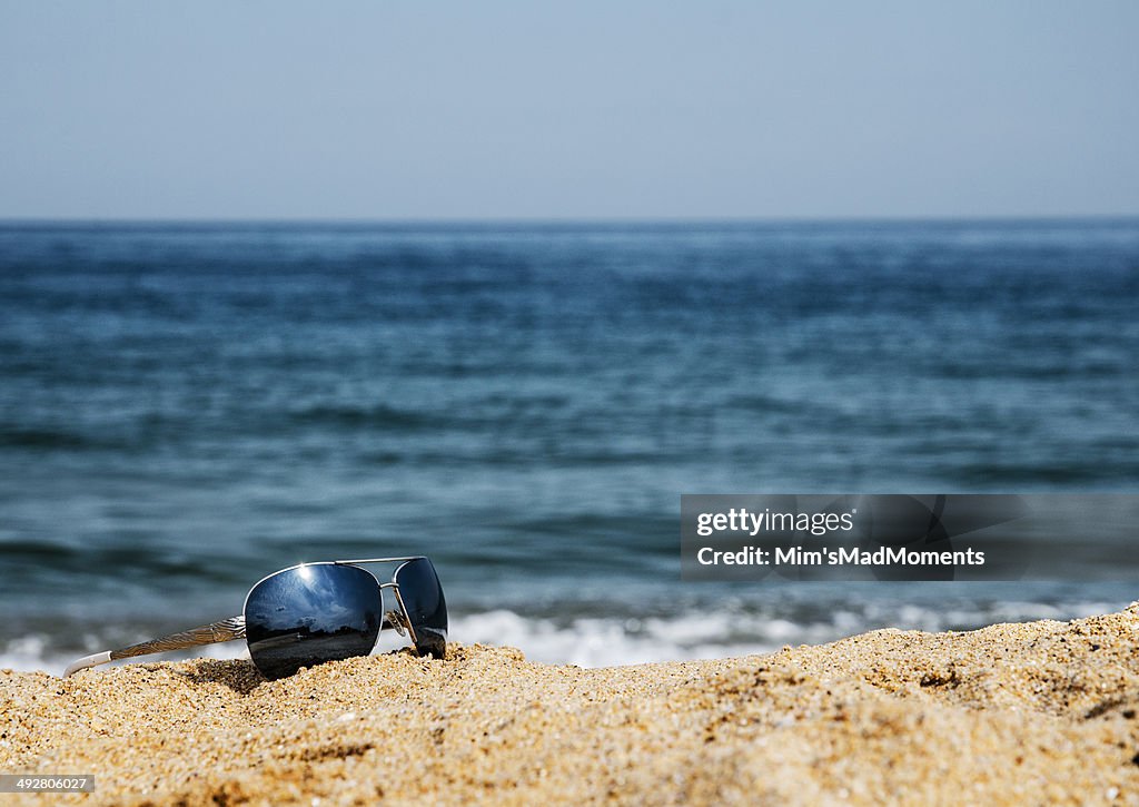 Sunglasses in the sand