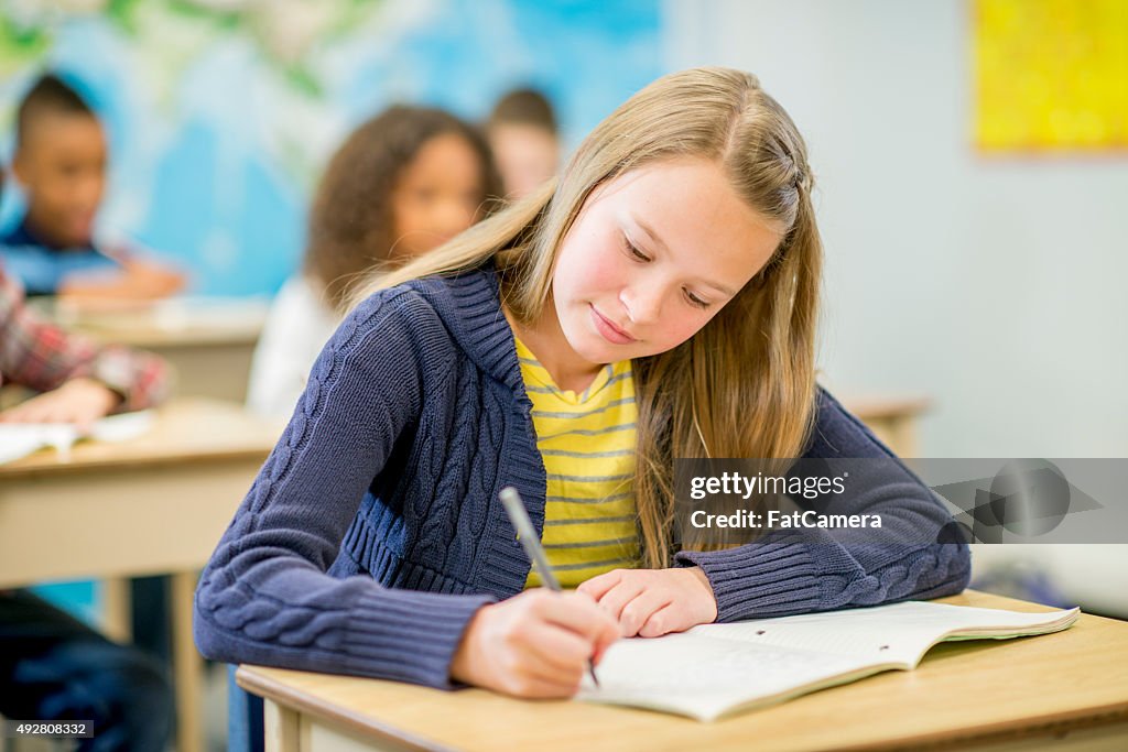 Student Writing In Notebook Elementary Student Writing In Notebook High-Res Stock Photo - Getty Images