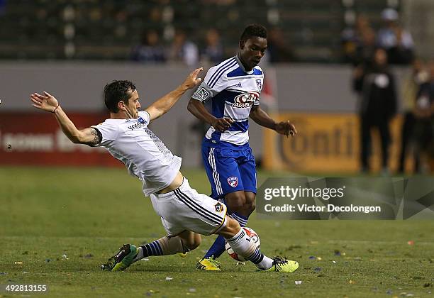 Dan Gargan of the Los Angeles Galaxy tackles Fabian Castillo of FC Dallas in the second half during the MLS match at StubHub Center on May 21, 2014...